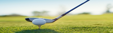 photo of tee, golf club and ball on the grass